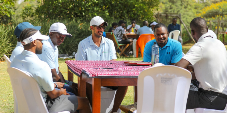 A group of professional golfers seated at their table during the event.