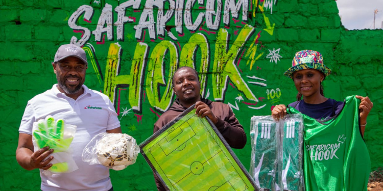 From left: Stephen Maundu, Territory Business Lead, Nairobi at Safaricom PLC, hands over football kits to Peter Njogu, Chairman of Kambi Safi Community, representing four community football teams, assisted by Susan Muthoka from the Youth Segment at Safaricom PLC.