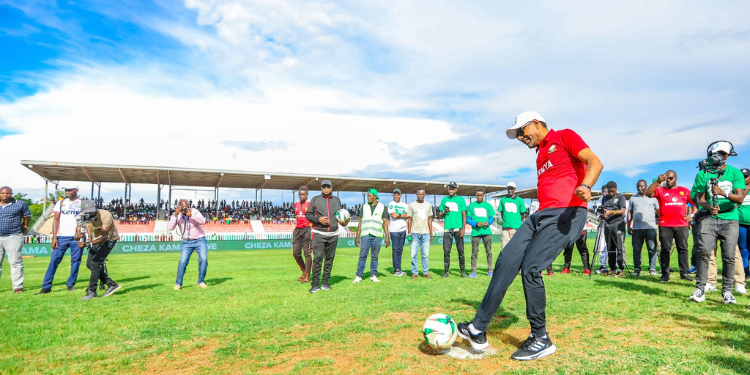 Football Kenya Federation (F.K.F) president Hussein Mohammed kicking a ball at the launch of Chapa Dimba season 5. Photo/ Courtesy, Safaricom PLC (X)
